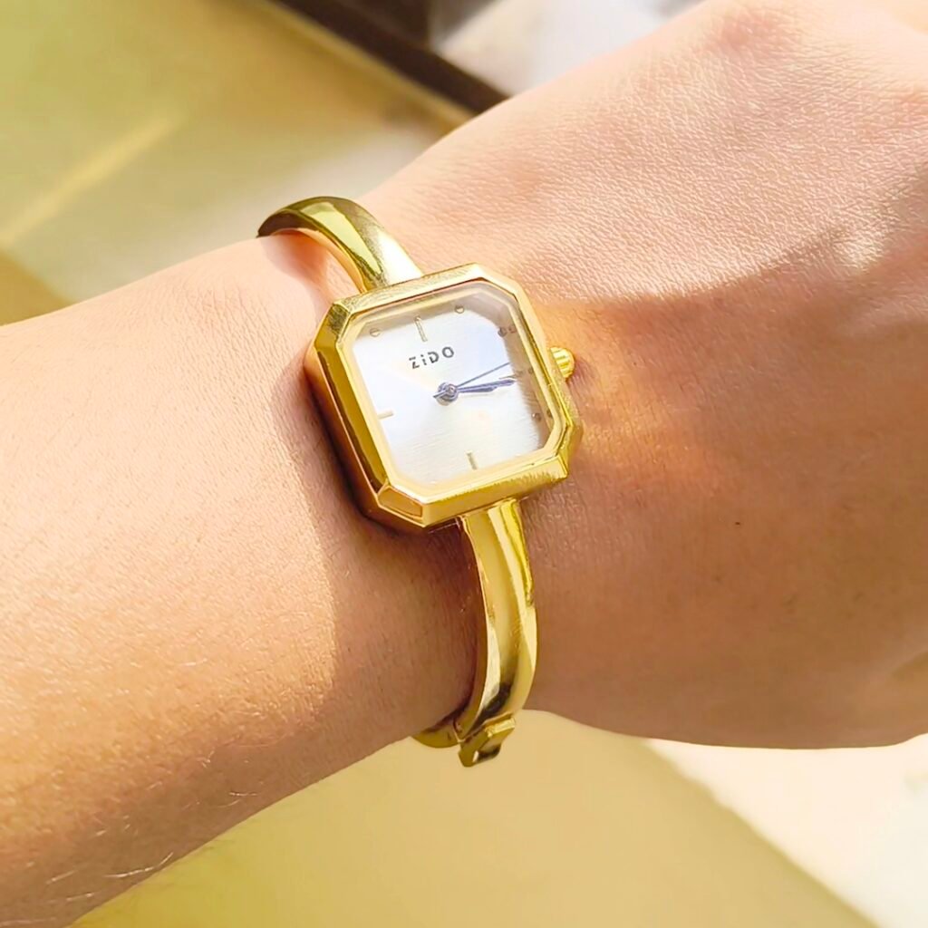 Elegant gold square bangle watch for women with a minimalist white dial and polished bracelet.