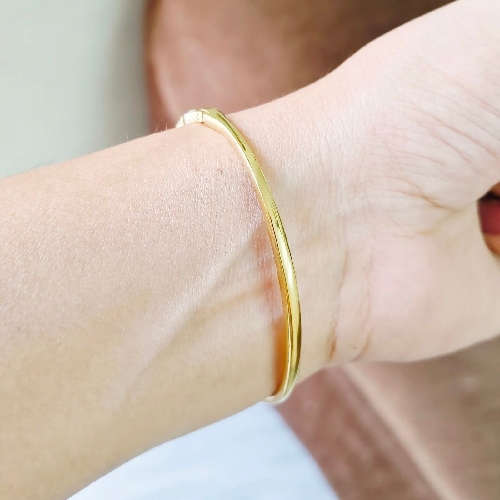 Aurora Prism Kada featuring baguette and round crystal accents in a gold-tone finish.