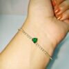 Elegant Emerald Heart Tennis Bracelet for Women featuring a green heart-shaped cubic zirconia stone with sparkling crystal tennis chain in a gold finish.