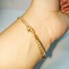 Elegant Emerald Heart Tennis Bracelet for Women featuring a green heart-shaped cubic zirconia stone with sparkling crystal tennis chain in a gold finish.